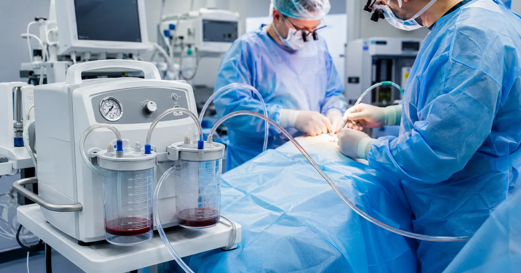 Surgical suction device in an operating room removing fluids to maintain a clear surgical field and 