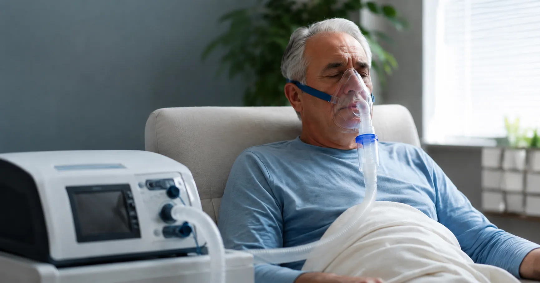 Emphysema patient at home using an oxygen concentrator with a pulse oximeter on their finger and a n