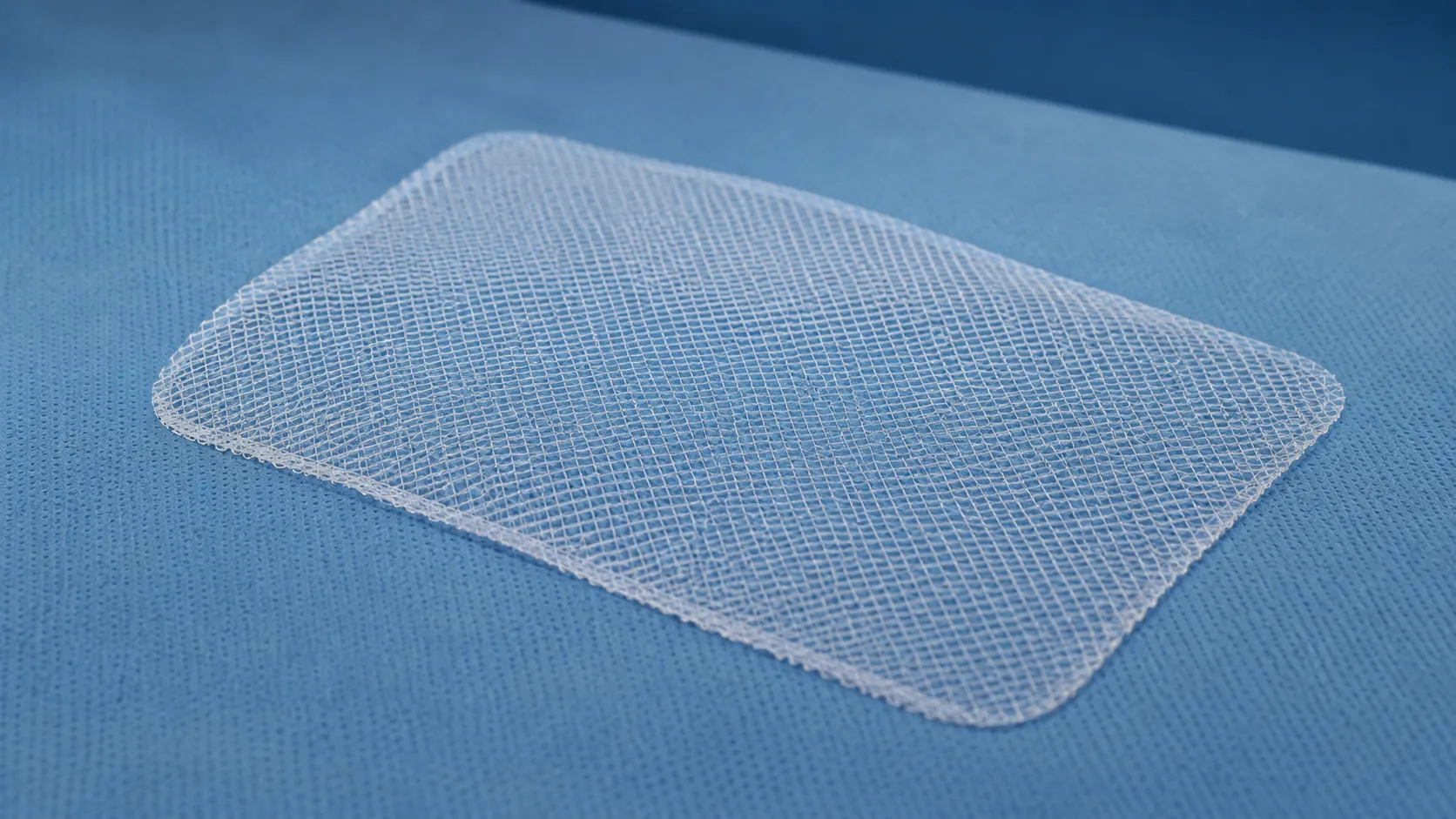 Flat knitted polypropylene surgical mesh sheet prepared for placement during an abdominal wall herni