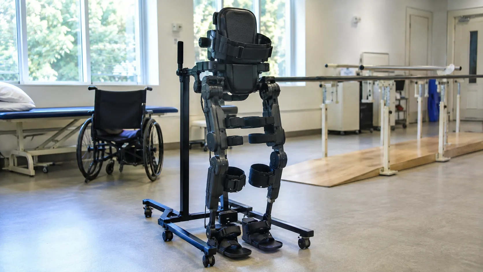 Patient standing in an overground robotic exoskeleton with a therapist supervising in a rehabilitati