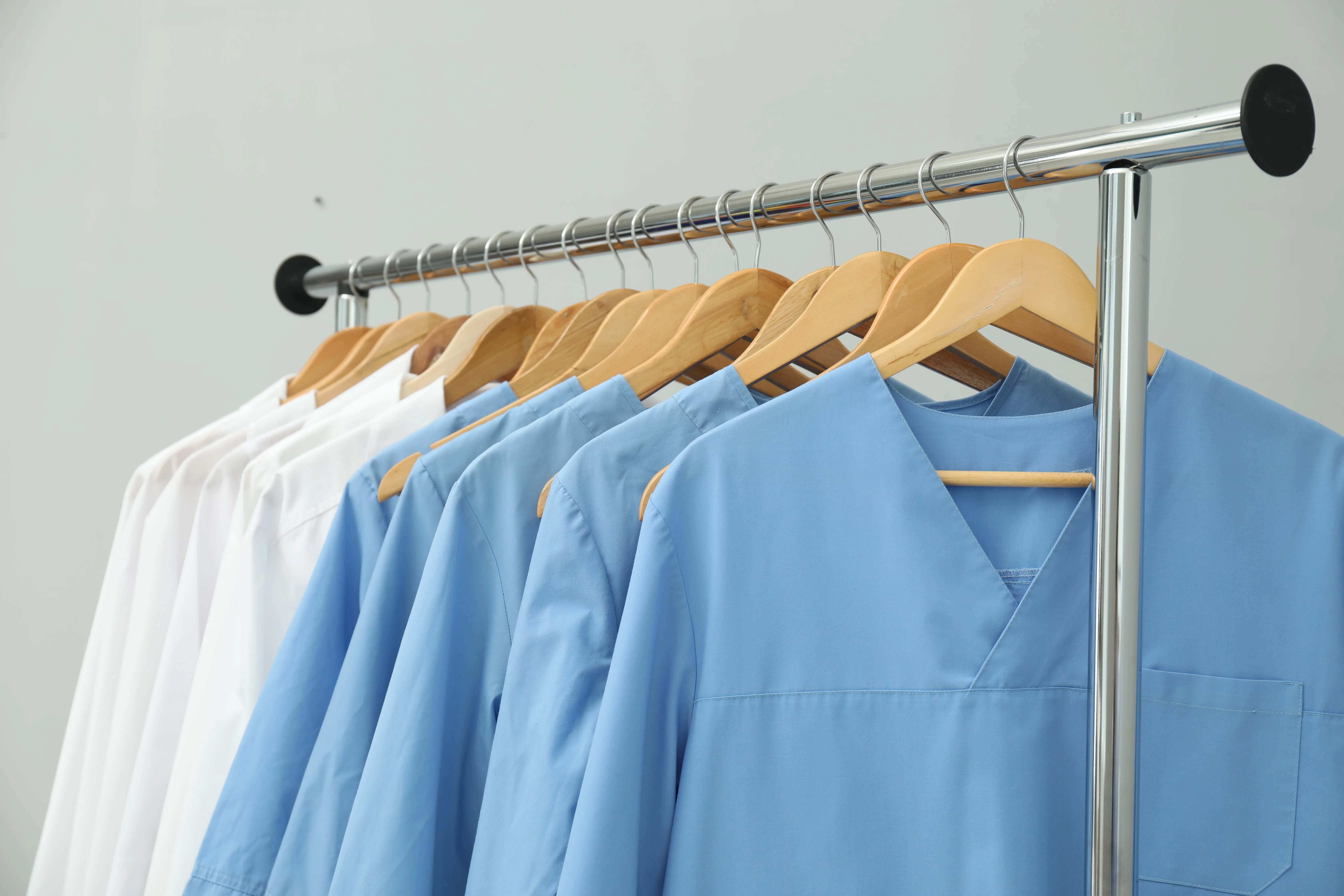 different-medical-workers39-uniforms-clothing-rack-against-grey-background