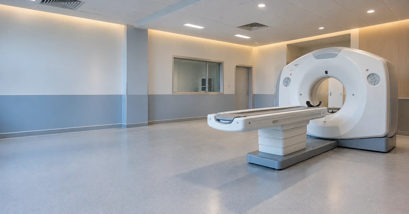 Medical physicist reviewing refurbished CT scanner dose QA images and X-ray tube usage data before p