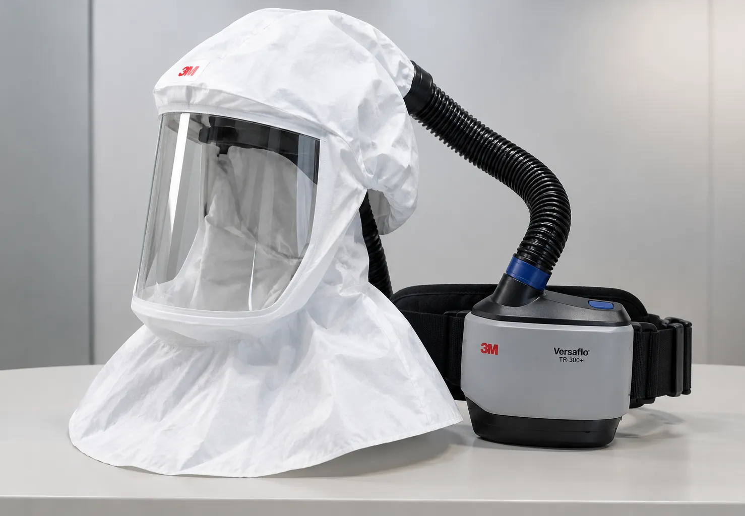 Clinician wearing a loose-fitting powered air purifying respirator hood with belt-mounted blower dur